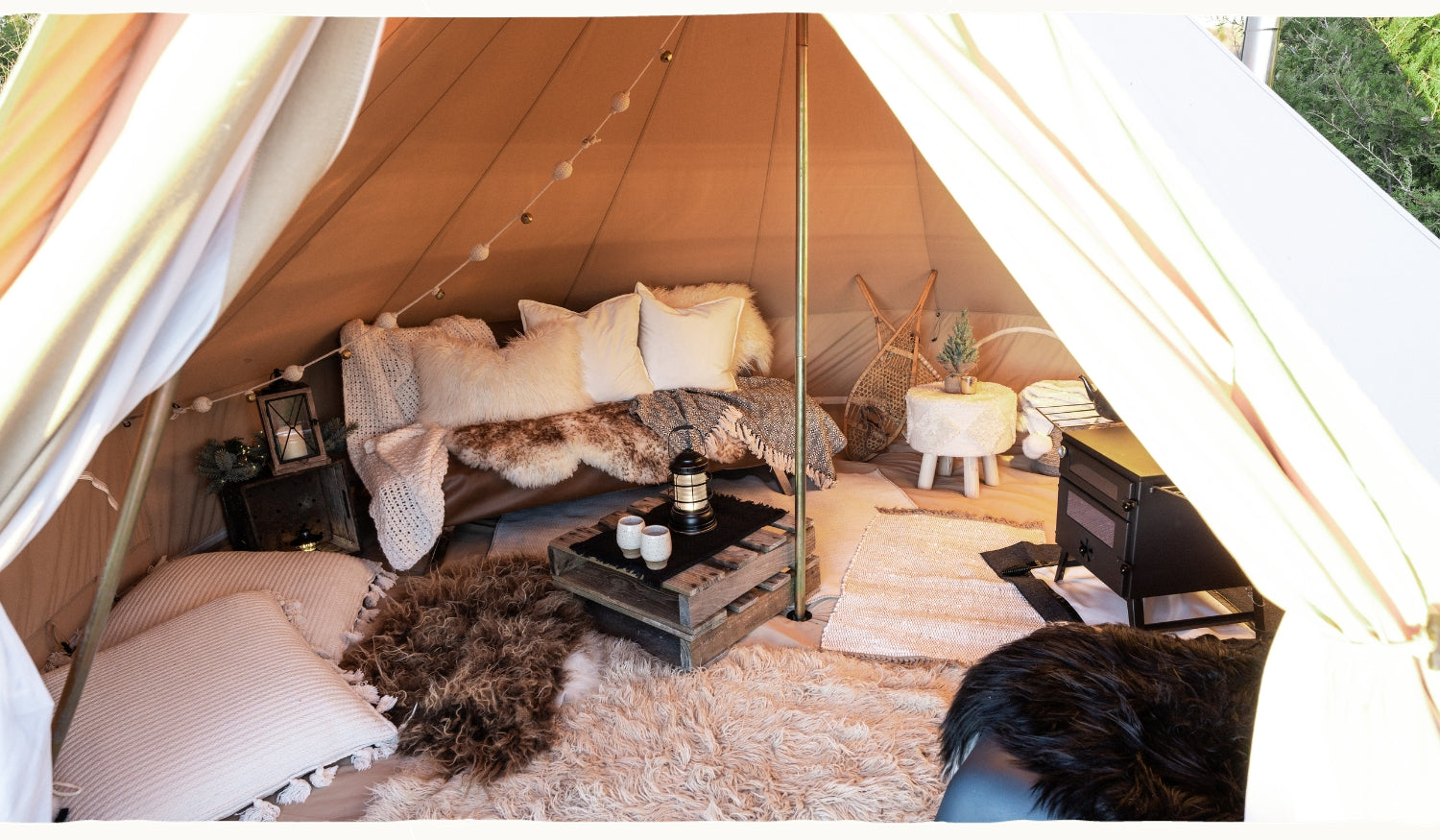 cosy boho bell tent interior with fluffy fur hides
